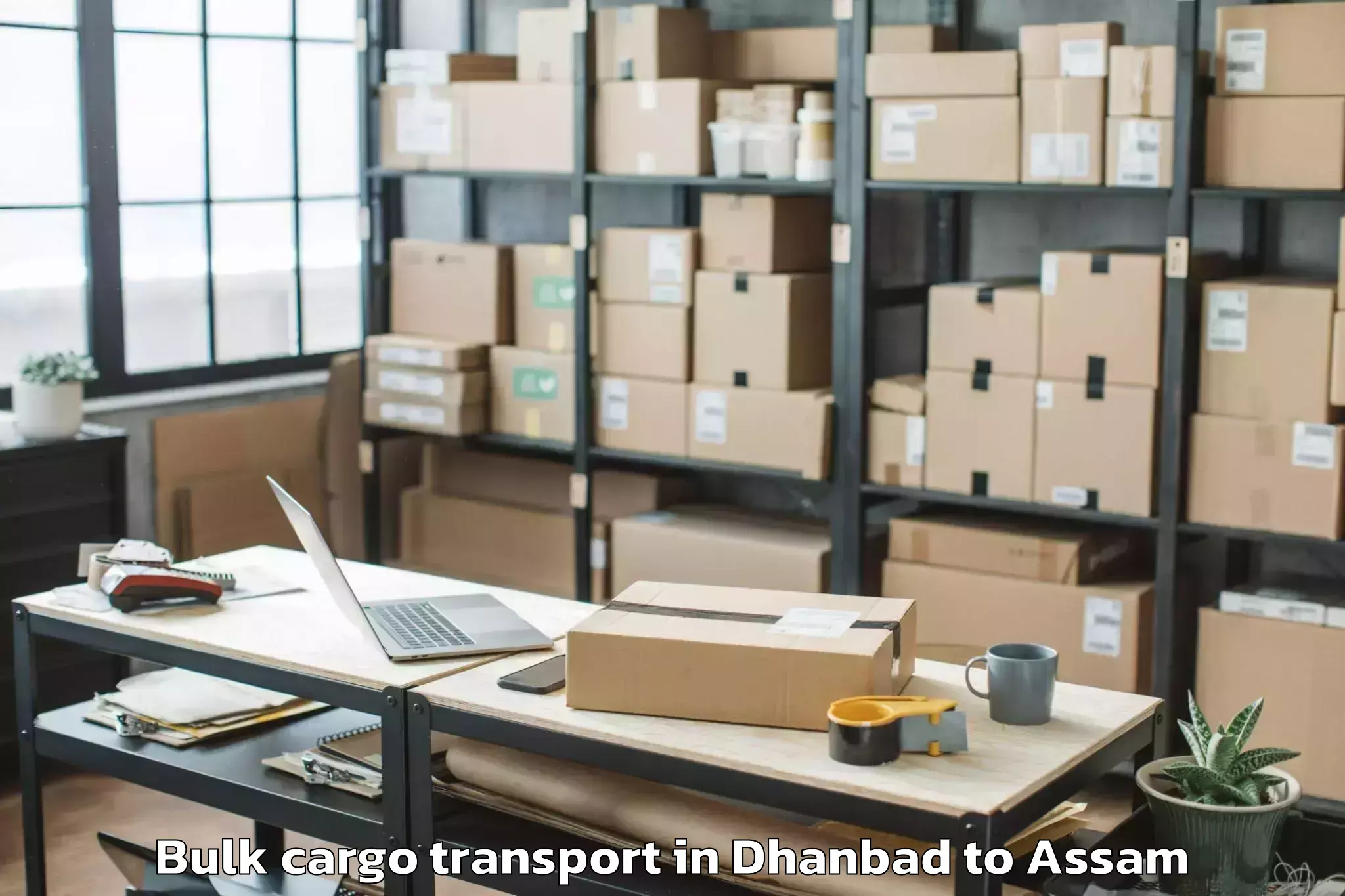 Trusted Dhanbad to Chapar Bulk Cargo Transport